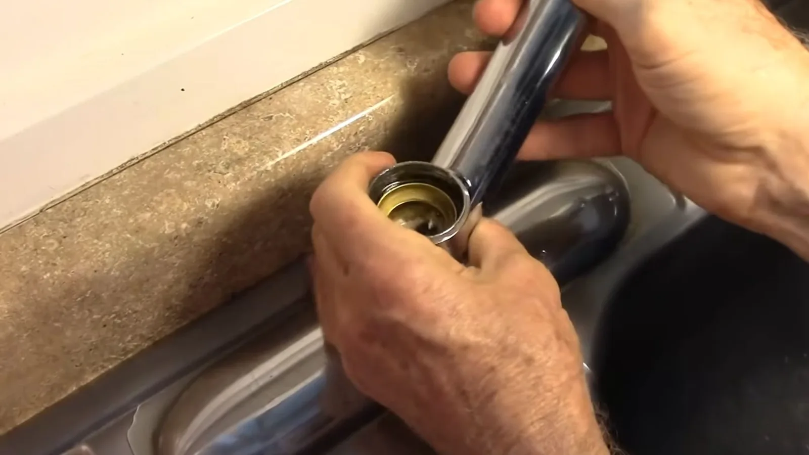 Technician installing a kitchen faucet
